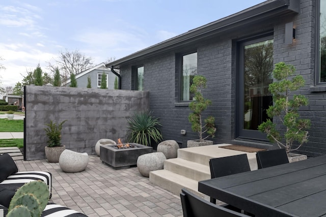 view of patio / terrace with a fire pit and outdoor dining area