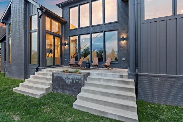 back of house with brick siding