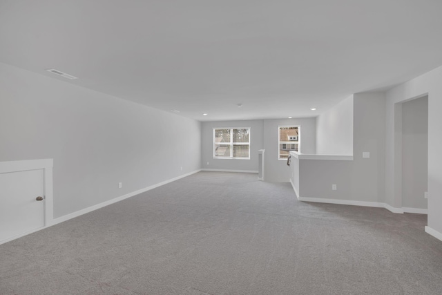 carpeted empty room featuring recessed lighting, baseboards, and visible vents