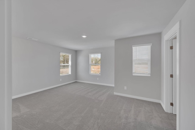 unfurnished room with baseboards and carpet flooring