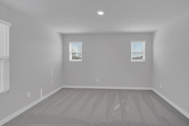 spare room with baseboards, carpet flooring, recessed lighting, and visible vents
