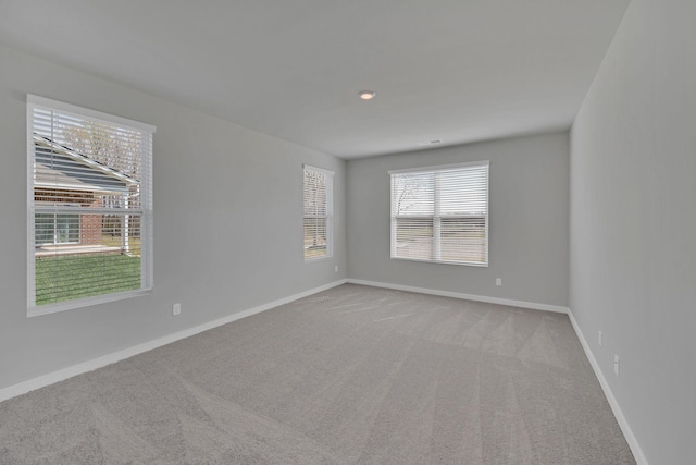 empty room with baseboards and carpet