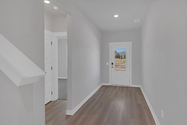interior space with baseboards, recessed lighting, and wood finished floors