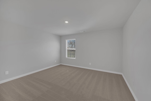 spare room with baseboards, carpet flooring, recessed lighting, and visible vents
