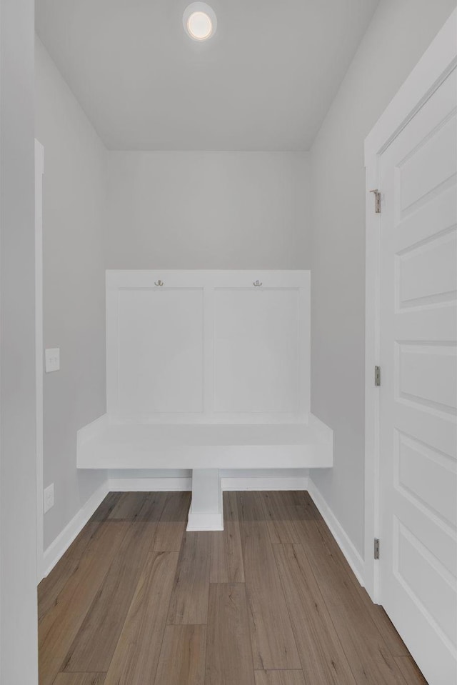 mudroom with baseboards and wood finished floors