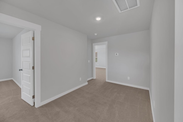 carpeted spare room featuring baseboards, recessed lighting, and visible vents