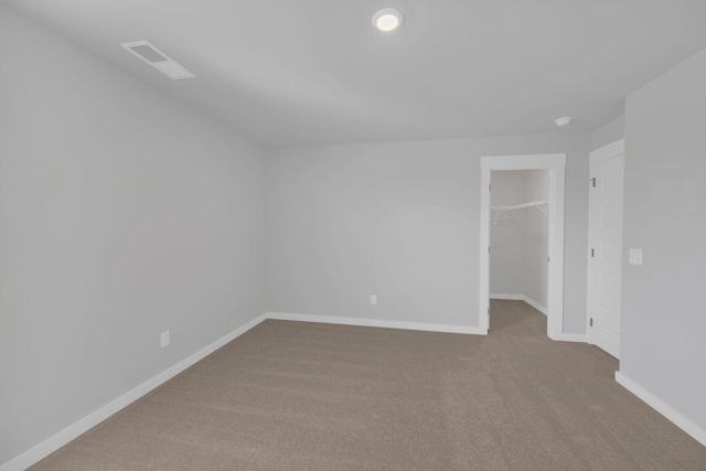 empty room featuring baseboards, carpet, and visible vents
