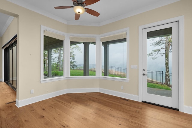 interior space featuring a ceiling fan, visible vents, a wealth of natural light, and light wood-style floors