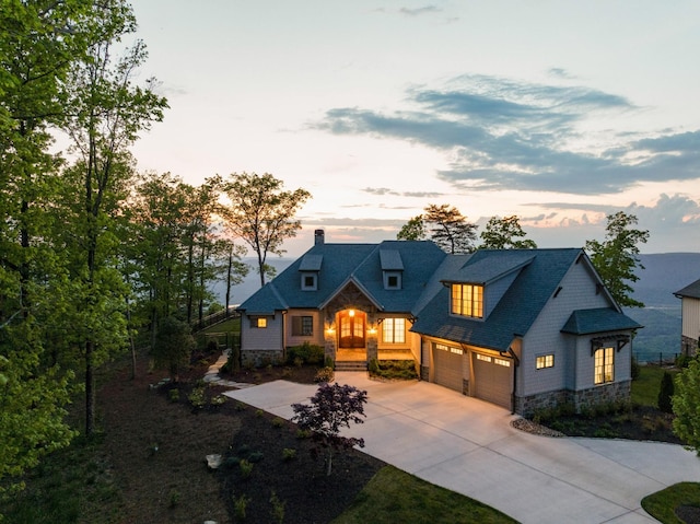 craftsman inspired home featuring driveway, a chimney, stone siding, and a garage