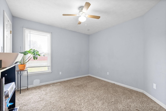 unfurnished office featuring visible vents, carpet flooring, and baseboards