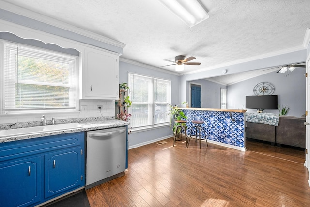 kitchen featuring a ceiling fan, a sink, blue cabinets, and dishwasher