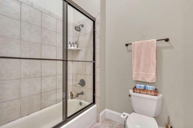 bathroom with toilet, baseboards, tile patterned floors, and shower / bath combination with glass door