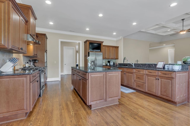 kitchen featuring appliances with stainless steel finishes, a center island, under cabinet range hood, coffered ceiling, and light wood-style flooring