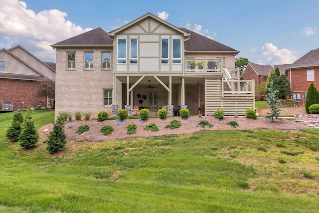 back of house featuring ceiling fan, a patio, brick siding, stairs, and a yard