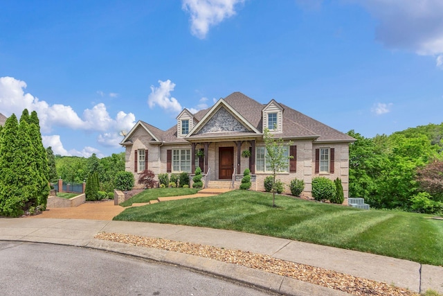 view of front of home with a front yard and brick siding