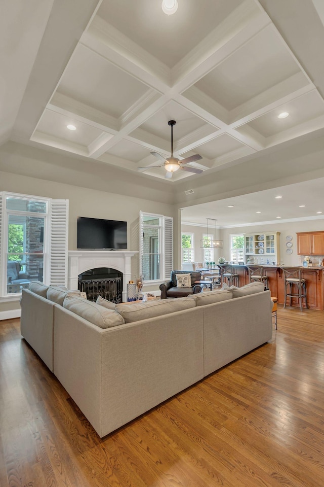 living area with ceiling fan, a fireplace, wood finished floors, coffered ceiling, and recessed lighting