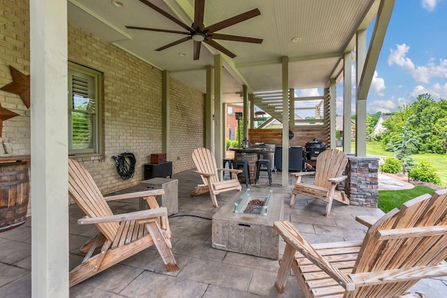 view of patio with ceiling fan and an outdoor fire pit