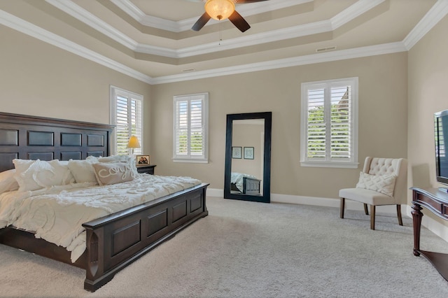 bedroom featuring a raised ceiling, ornamental molding, light carpet, and visible vents