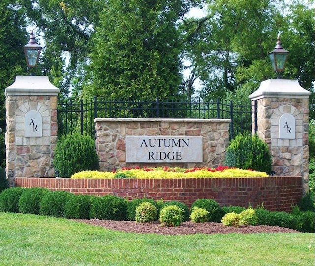 community / neighborhood sign with fence