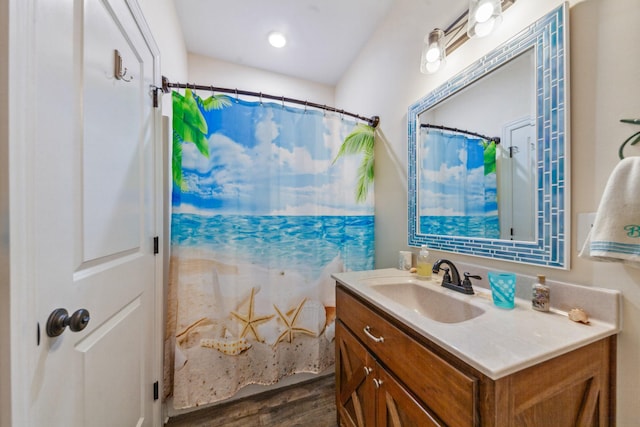 full bath featuring a shower with curtain, vanity, and wood finished floors