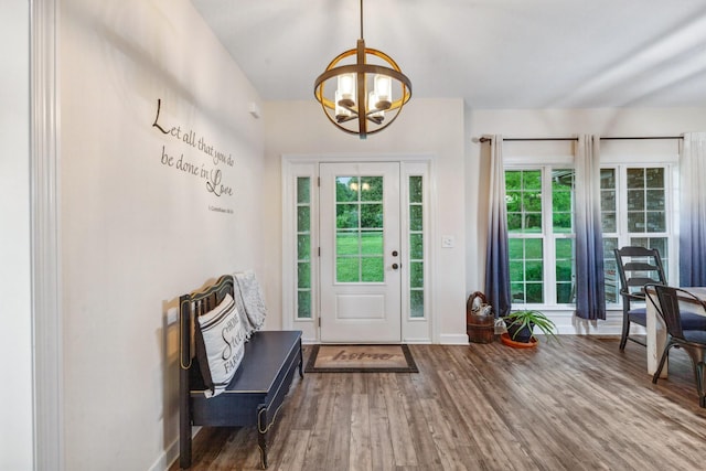 entryway featuring baseboards, an inviting chandelier, and wood finished floors