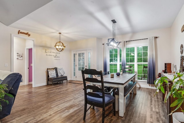 dining room with a notable chandelier and wood finished floors