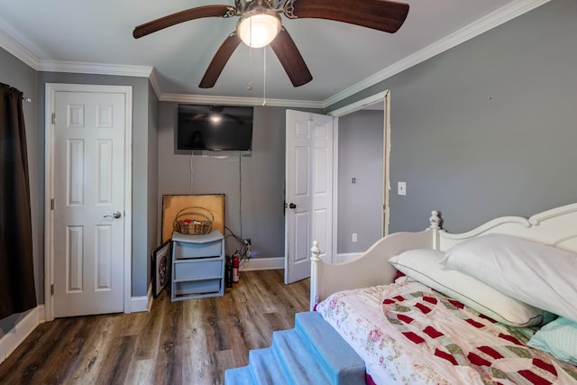 bedroom featuring crown molding, baseboards, and wood finished floors