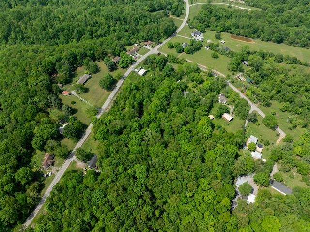 birds eye view of property featuring a forest view