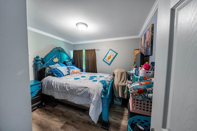 bedroom featuring ornamental molding and wood finished floors