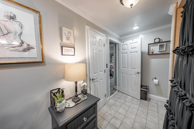 entrance foyer with light tile patterned floors, baseboards, and ornamental molding
