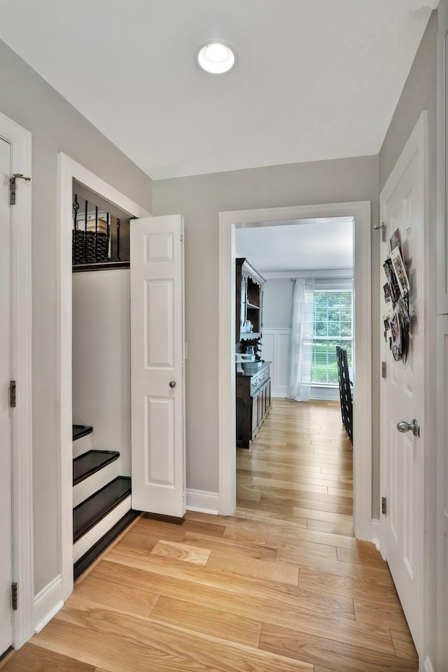 hallway with light wood-style floors and baseboards
