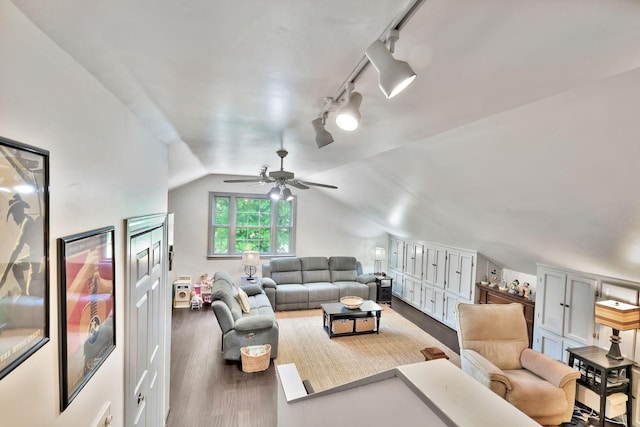 living room with a ceiling fan, vaulted ceiling, track lighting, and wood finished floors