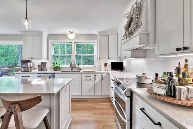 kitchen with plenty of natural light, white cabinets, and a sink