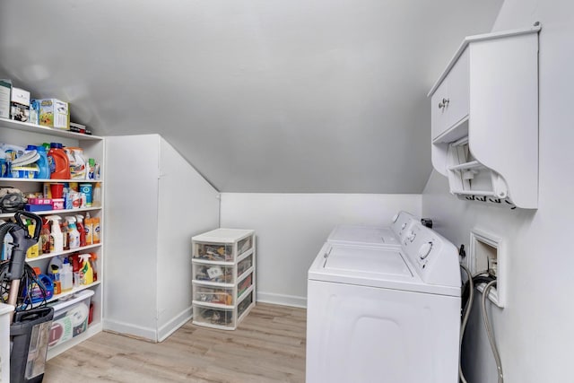 washroom featuring cabinet space, light wood-type flooring, separate washer and dryer, and baseboards