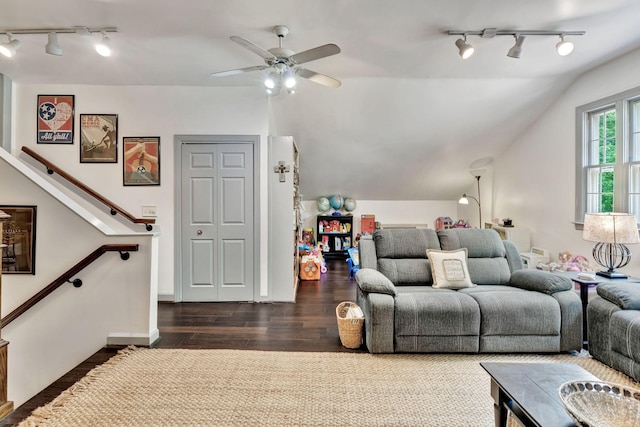 living area featuring rail lighting, vaulted ceiling, ceiling fan, and dark wood-style floors