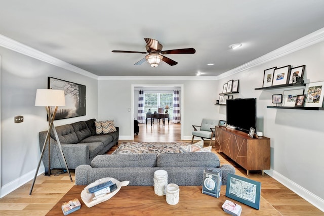 living room with crown molding, baseboards, a ceiling fan, and wood finished floors