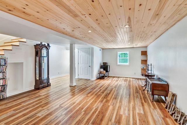 additional living space with stairway, wood finished floors, baseboards, and recessed lighting