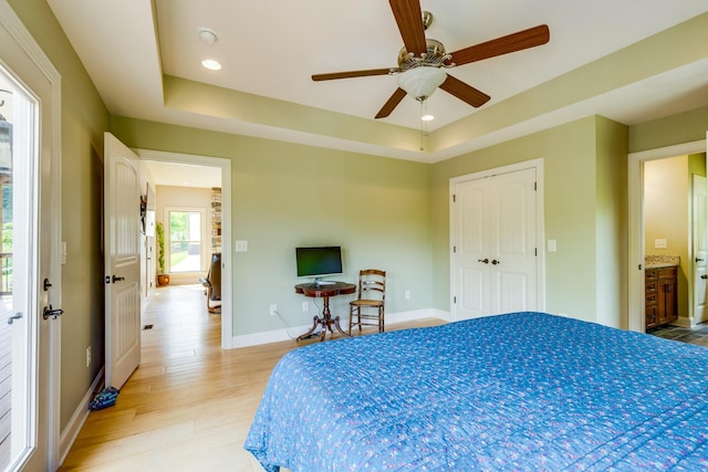 1545 Gravel Hill Rd, Columbia, TN 38401 - bedroom featuring a ceiling fan, baseboards, a tray ceiling, and light wood-style floors