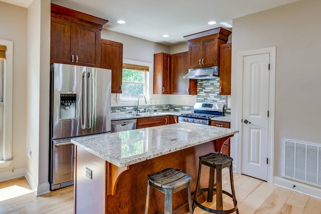 1545 Gravel Hill Rd, Columbia, TN 38401 - kitchen with visible vents, appliances with stainless steel finishes, tasteful backsplash, a sink, and under cabinet range hood