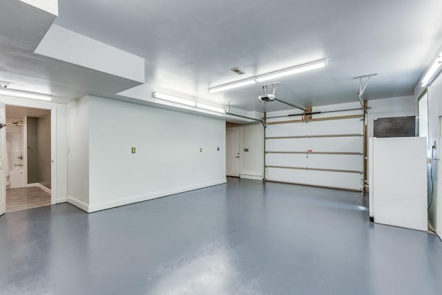 1545 Gravel Hill Rd, Columbia, TN 38401 - garage featuring baseboards and a garage door opener