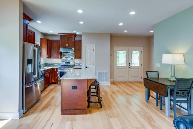 1545 Gravel Hill Rd, Columbia, TN 38401 - kitchen with a breakfast bar area, visible vents, appliances with stainless steel finishes, a center island, and under cabinet range hood