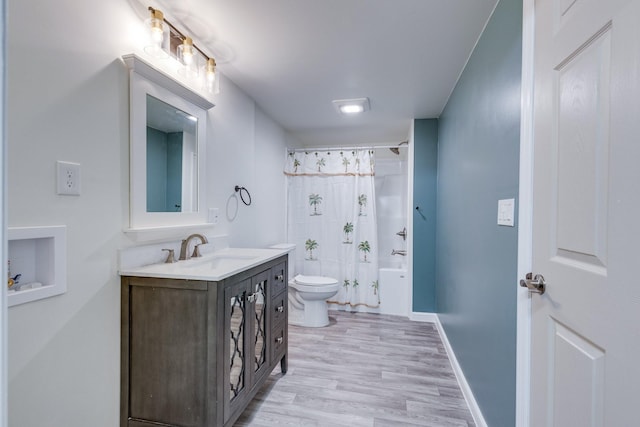 1545 Gravel Hill Rd, Columbia, TN 38401 - full bath featuring vanity, wood finished floors, toilet, baseboards, and shower / bathtub combination with curtain