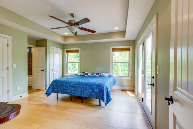 1545 Gravel Hill Rd, Columbia, TN 38401 - bedroom featuring visible vents, baseboards, light wood-type flooring, a raised ceiling, and a ceiling fan