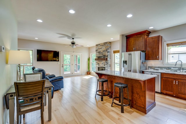 1545 Gravel Hill Rd, Columbia, TN 38401 - kitchen featuring a sink, light stone countertops, open floor plan, a ceiling fan, and appliances with stainless steel finishes