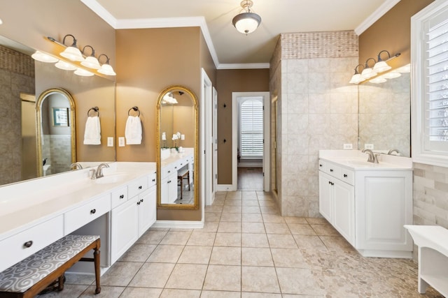 full bathroom featuring plenty of natural light, ornamental molding, a sink, and two vanities