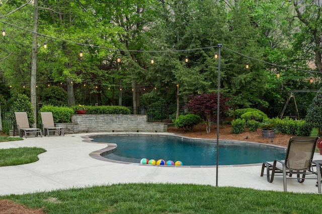 pool featuring a patio and fence