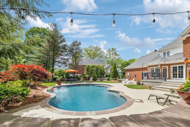 outdoor pool featuring a patio