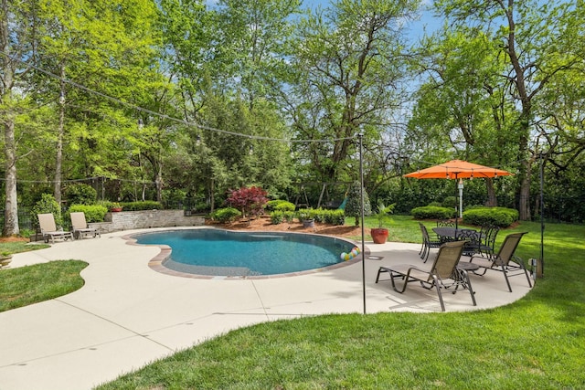 outdoor pool with fence, a yard, and a patio area