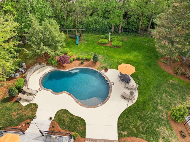 pool with a lawn and a patio area