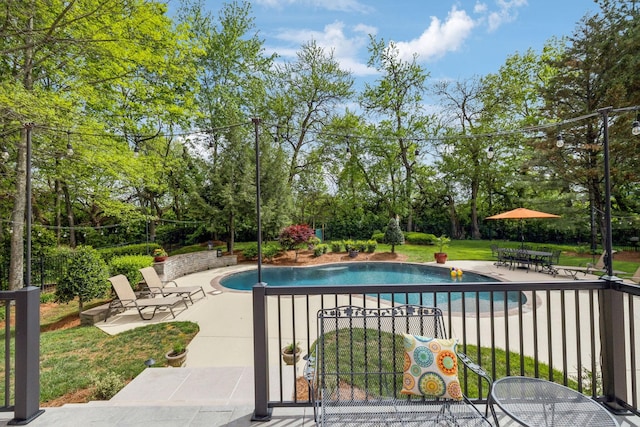 outdoor pool featuring a patio and a yard